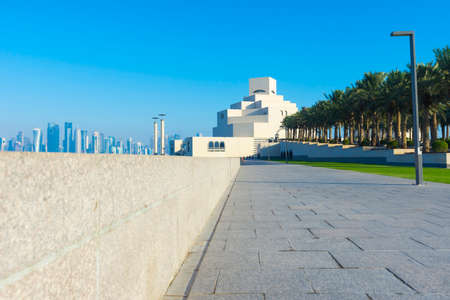 Museum of Islamic Art , Doha,Qatar in daylight exterior view with Arabic gulf in the foreground and clouds in the sky in the backgroundのeditorial素材