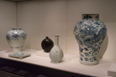 Old and vintage ceramic vase and statue of Chinese art on display in museum.