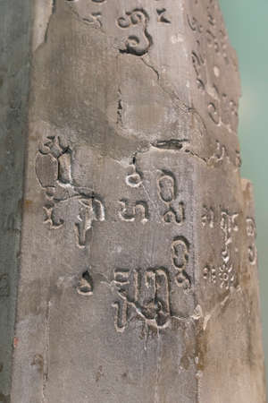 Old script in Sanskrit language on stone found in Thailandのeditorial素材