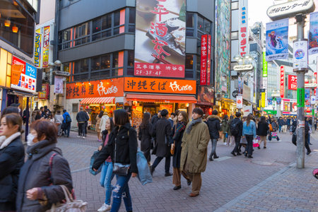 Unidentified people walk around Shibuya shopping street in Tokyo, Japan