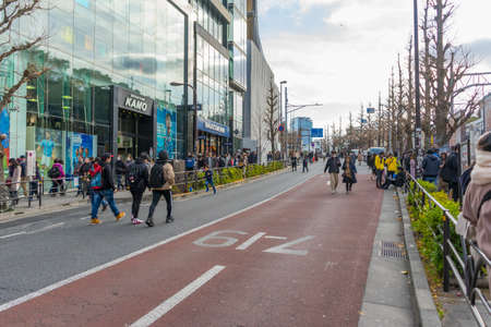 Crowd of people walking in front of Harajuku train station in Tokyo, Japanのeditorial素材