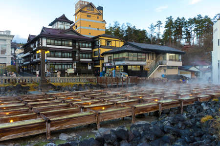 Unidentified people sightseeing at Yubatake Hotspring with evening light in Gunma ,Japan