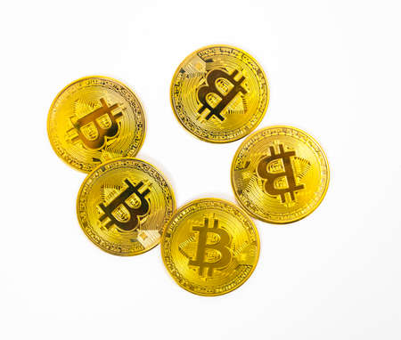 Five Bitcoin tokens stacked isolated on white background.の写真素材