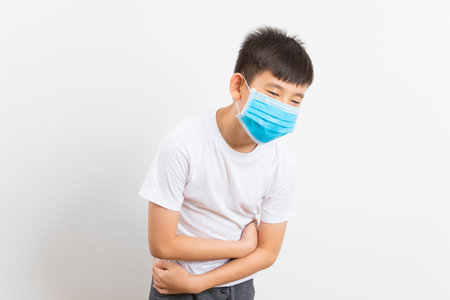 Asian boy wearing a mask getting sick by COVID - 19 on a white background.