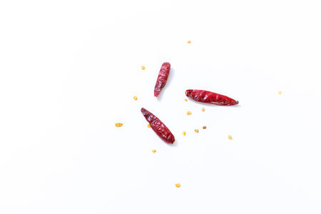 Dried red chili on white background, pile of red dried chilli pepper cayenne.