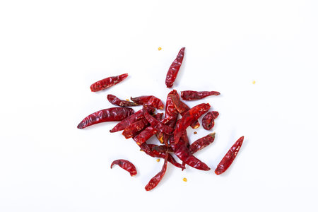 Dried red chili on white background, pile of red dried chilli pepper cayenne.