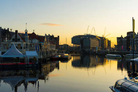 Beautiful sunrise view of DoubleTree Hilton hotel, around the Central railway Station in Amsterdam, Netherlandsのeditorial素材