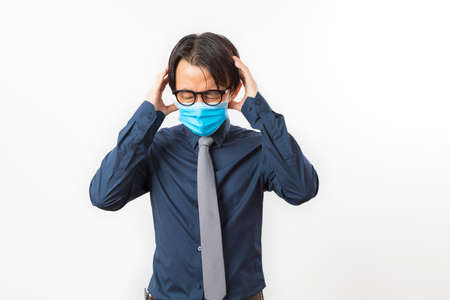 portrait of businessman wearing blue face mask suffer from covid-19 symptom isolated on white background.の写真素材