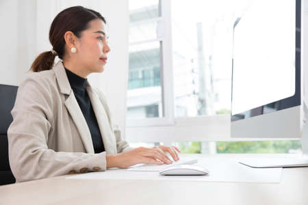 Beautiful Asian woman work from home, working on computer in at home. Social distancing lifestyle.の写真素材