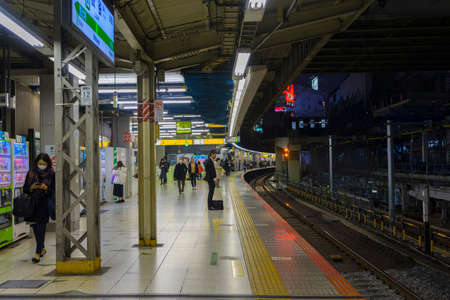 Tokyo, Japan - Dec 18,2019 : Unidentified people standing on the platform of train station in Tokyo, Japan on Dec 18,2019.のeditorial素材