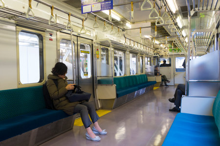 Unidentified people standing on the platform of train station in Japan.のeditorial素材