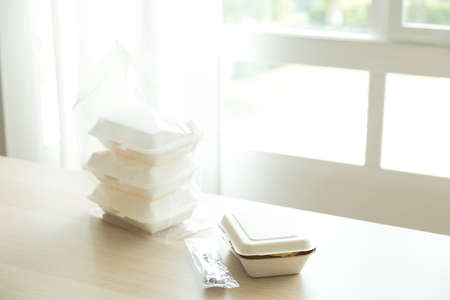 Thai food in paper delivery box on wood table at home.の写真素材