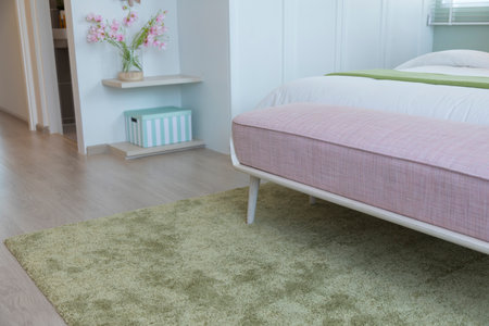 Close up of carpet by the bed, close up near the bed and the bench.の写真素材