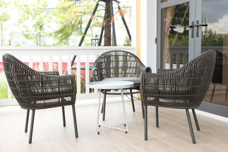 Three Wicker chairs and table on the outdoor terrace