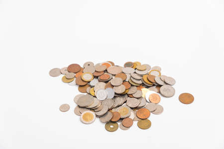Many kind of coin country pile up on white background.の写真素材