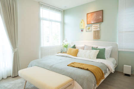 Stylish bedroom with modern green and yellow pillow and furniture. Interior designの写真素材