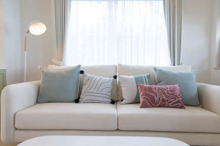 Sofa with purple and green pillows in living room at home.の写真素材