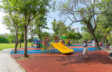 Bangkok, Thailand - April 24, 2022 : Children and family happily have fun at playground in public park in Bangkok, Thailand on April 24, 2022.のeditorial素材