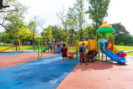 Bangkok, Thailand - April 24, 2022 : Children and family happily have fun at playground in public park in Bangkok, Thailand on April 24, 2022.のeditorial素材