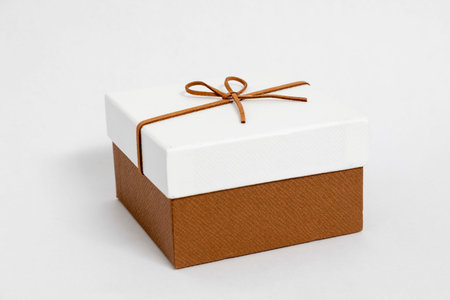 Gift box with brown ribbon on white background. Isolated.の写真素材