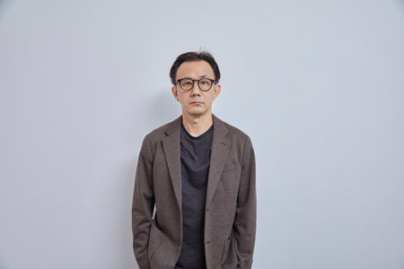 Portrait of Asian man wearing jacket and eyeglasses on white backgroundの写真素材
