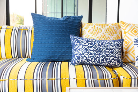 Mediterranean living room interior with bright yellow and blue sofa and pillow. Modern decor living room with carpet.の写真素材