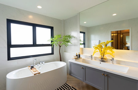 Interior of a modern bathroom with white bathtub and faucetの写真素材