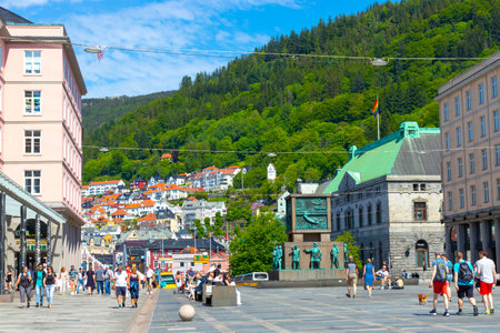 Tourists walk along the promenade in Bergen, Norway. Bergen is the capital and largest city of Norway.の写真素材