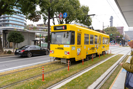 classic yellow tram of Kumamoto city in Kumamoto, Japanの写真素材