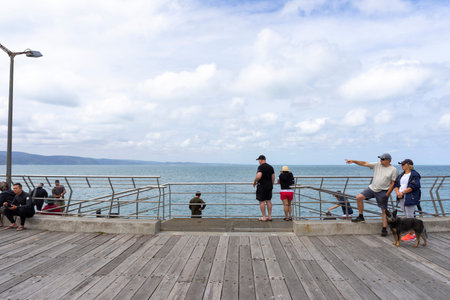 Lorne, Victoria, Australia - January 1,2024 : Families and children are fishing at Lorne Pier with...