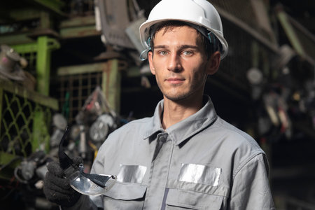 Portrait of technician worker working in garage scrap yard car workshop warehouse.の写真素材