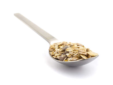 A spoon with some muesli isolated on a white backgroundの写真素材