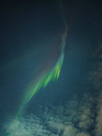 Strip of strong aurora in night sky with some clouds in Rovaniemi, Laplandの写真素材