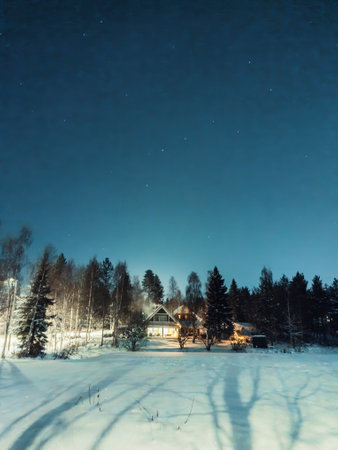 House in snowy winter forest in Rovaniemi, Lapland in the polar nightの写真素材