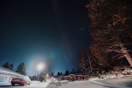 Faint aurora over snowy neighbourhood in winter in Rovaniemi, Laplandの写真素材