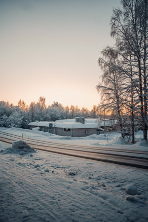 Sunrise between old closed down shop in the snow in Rovaniemi, Laplandの写真素材