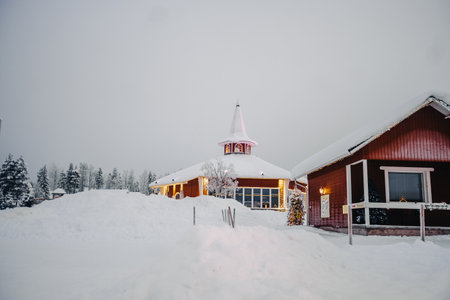 Red houses in Santa Claus' Village in the snow in Rovaniemi, Laplandの写真素材