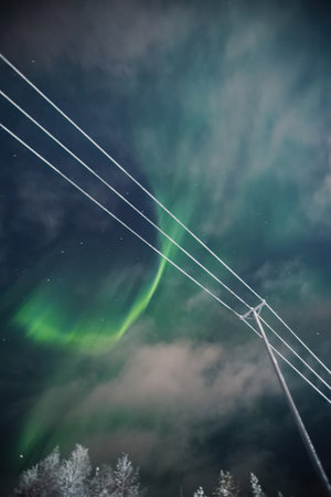 Aurora borealis green explosion above power lines in Rovaniemi, Laplandの写真素材