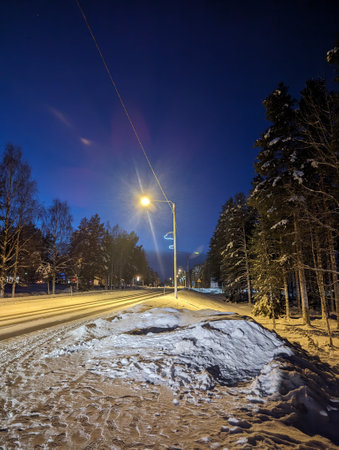 Snowy street at night with streetlights in Ranua, Laplandの写真素材