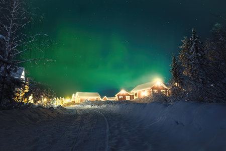 Northern lights in starry sky above Santa Claus' Village in Rovaniemi, Laplandの写真素材