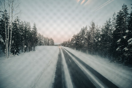 Arctic road shot from back window of coach in Ranua, Laplandの写真素材