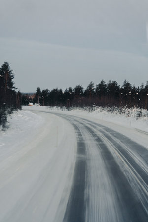 Snowy road through the Lapland wilderness in Ranua, Laplandの写真素材