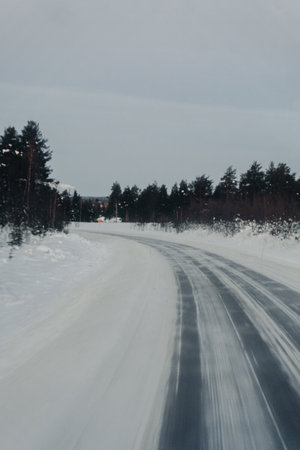 Snowy road through the arctic wilderness in Ranua, Laplandの写真素材