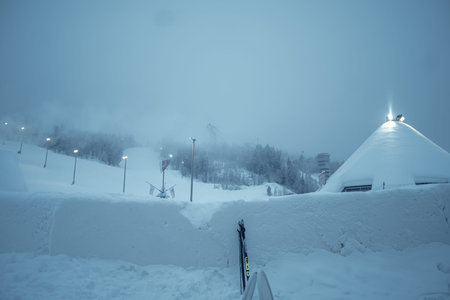 Snowy Ounasvaara ski resort in twilight on misty winter day in Rovaniemi Lapland