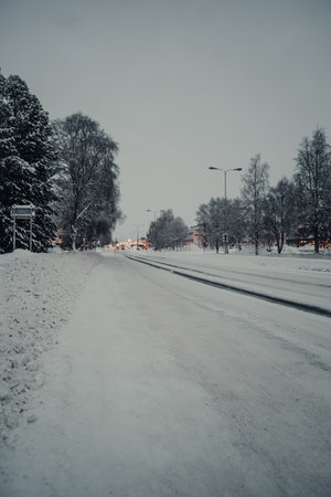 Snowy icy road into the centre of Rovaniemi in Laplandの写真素材