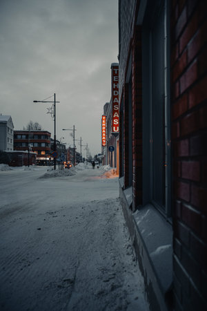 Snowy street in the centre of Rovaniemi in winter with shops in Lapland