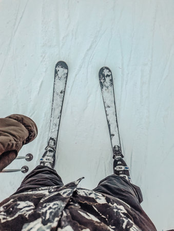 POV Looking down at skis in the snow in Rovaniemi, Laplandの写真素材