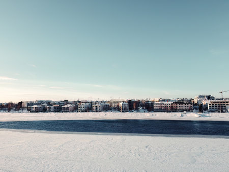 Half frozen Ounasjoki river in front of Rovaniemi aerial shot in Laplandの写真素材