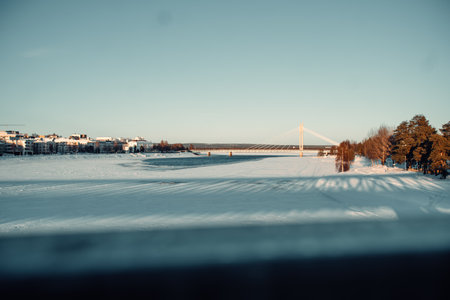 Mostly frozen Ounasjoki river under candlestick bridge in Rovaniemi, Laplandの写真素材