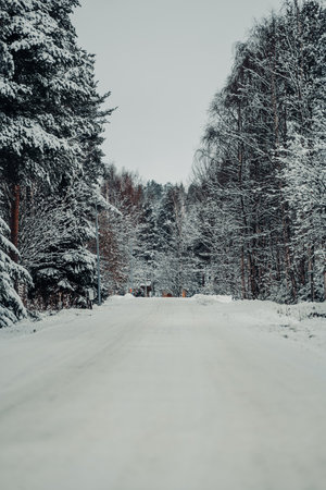 Snowy street through neigbourhood outside of Rovaniemi in winter in Laplandの写真素材
